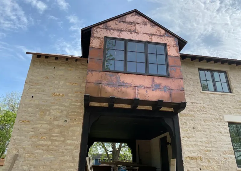 Copper metal panel facade on a stone building for Roof Repair in San Tan Valley