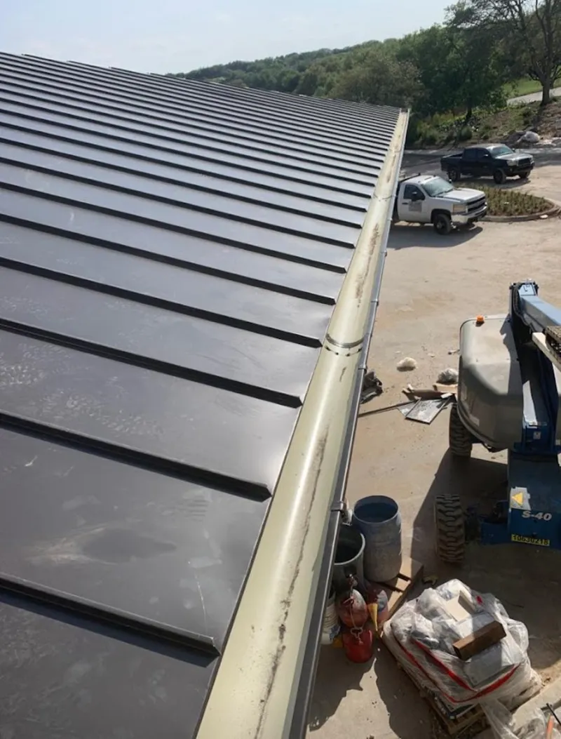 Standing seam panel and gutter detail on a metal roofing jobsite in San Tan Valley